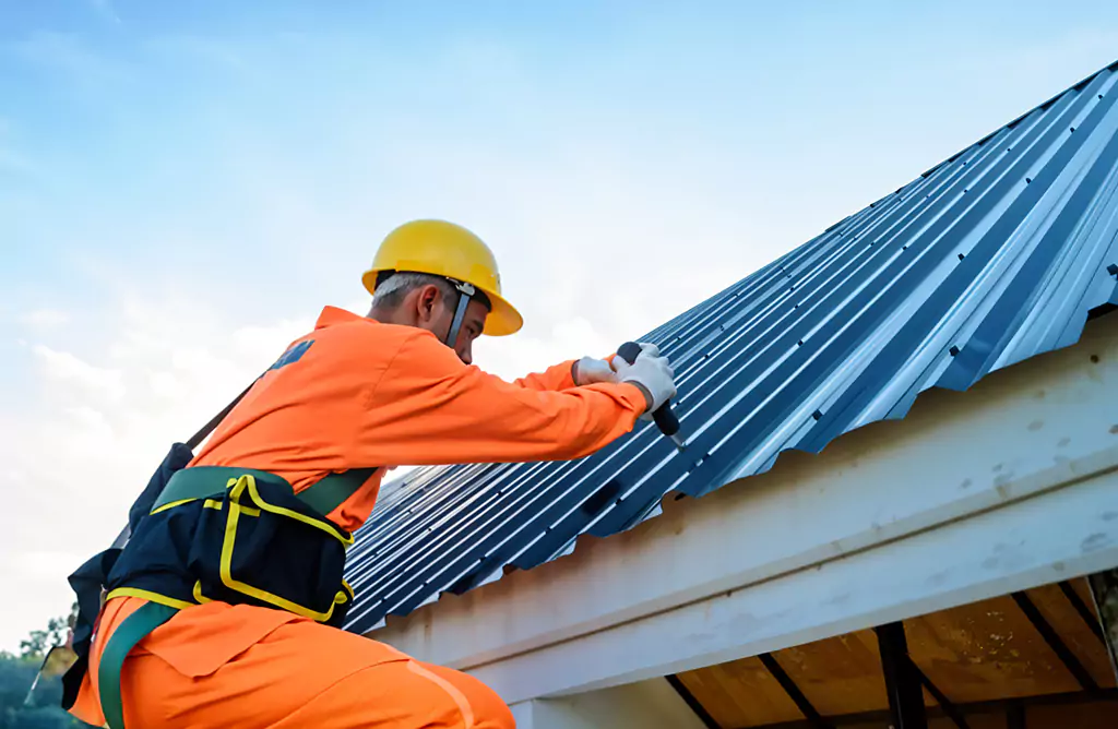Worker Installing Durable Metal Roofing Sheets