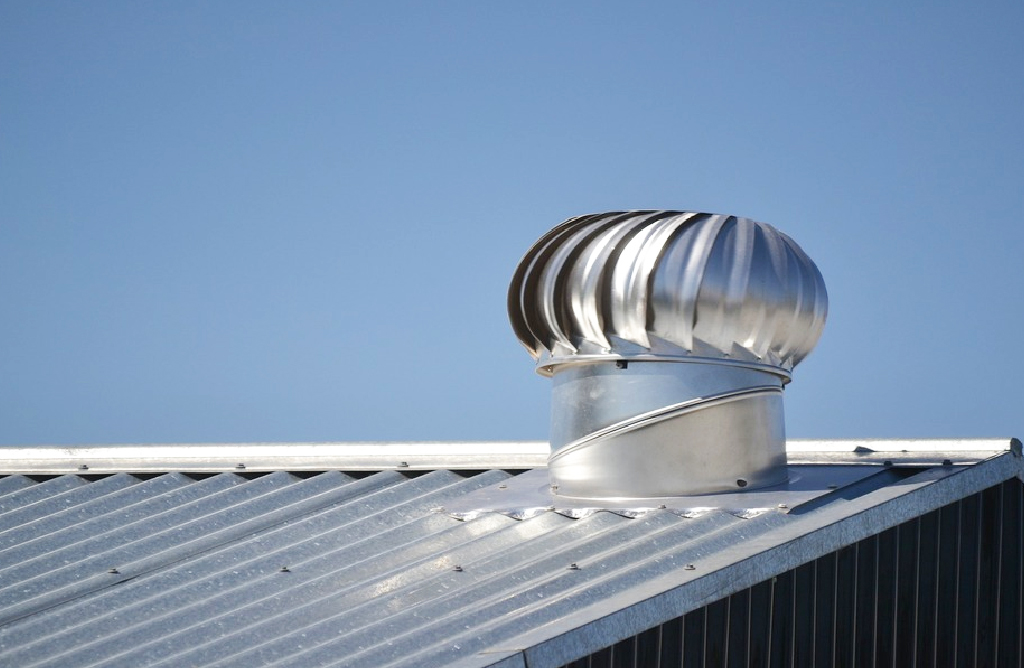 Roofing Ventilator on a Metal Roof Against the Blue Sky