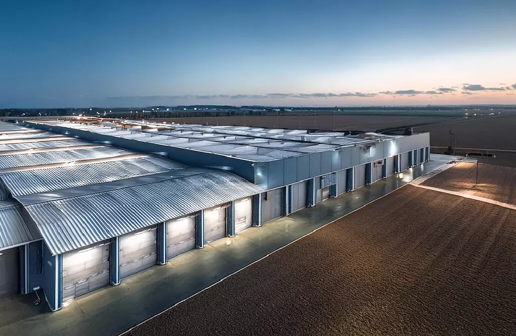 Large Warehouse with a Metal Roof at Dusk